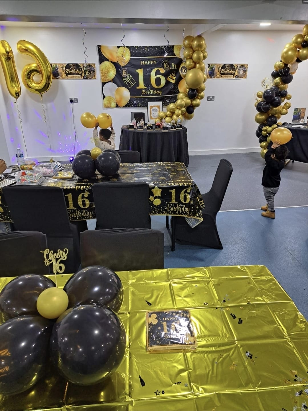 Black and gold sixteenth birthday setup