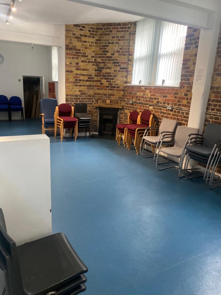 The Small Hall at St Jude's Centre with exposed brick wall and flexible seating